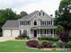 Charming two-story home featuring a welcoming front porch, well-manicured lawn, and a two-car garage at 21 Devin Lane Ln, Euharlee, GA 30145