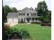 Beautiful two-story home on Devin Lane boasts a manicured lawn, lush landscaping, and a classic design at 21 Devin Lane Ln, Euharlee, GA 30145