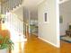 Sunlit foyer with hardwood floors, staircase, and a glimpse into the living room at 21 Devin Lane Ln, Euharlee, GA 30145