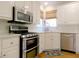 Updated kitchen with stainless steel appliances, white cabinets and subway tile at 21 Devin Lane Ln, Euharlee, GA 30145