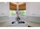 Corner kitchen sink with white countertops, subway tile backsplash, and brown window coverings at 21 Devin Lane Ln, Euharlee, GA 30145
