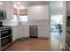 Bright kitchen featuring white cabinets, stainless steel appliances, and a subway tile backsplash at 21 Devin Lane Ln, Euharlee, GA 30145