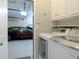 Laundry room with white washer and dryer, leading to a two car garage at 21 Devin Lane Ln, Euharlee, GA 30145