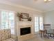 Living room fireplace with french doors and shuttered windows offers a bright and relaxing setting at 21 Devin Lane Ln, Euharlee, GA 30145