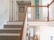 Carpeted staircase with white railings and natural wood trim, leading to the upper level at 21 Devin Lane Ln, Euharlee, GA 30145