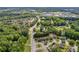 Aerial view of the property showcasing its location within a lush, green residential area near roadways at 3642 S Bogan Rd, Buford, GA 30519