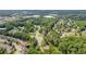 Expansive aerial view of a residential neighborhood with lush greenery and nearby commercial areas at 3642 S Bogan Rd, Buford, GA 30519