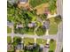 Aerial view of home surrounded by mature trees, lush green lawns, and neighboring homes at 3642 S Bogan Rd, Buford, GA 30519
