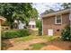 View of backyard with a brick house, fenced yard and a glimpse of neighboring properties at 3642 S Bogan Rd, Buford, GA 30519