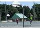 Outdoor basketball court featuring a person shooting a basketball towards the net at 3642 S Bogan Rd, Buford, GA 30519