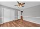 Cozy bedroom featuring wood floors, large window and light-colored walls at 3642 S Bogan Rd, Buford, GA 30519