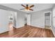 Bedroom features wood floors, three doors and a ceiling fan at 3642 S Bogan Rd, Buford, GA 30519
