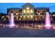Striking view of a well-lit community building featuring a fountain display, perfect for evening enjoyment at 3642 S Bogan Rd, Buford, GA 30519
