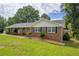 Ranch style home with nice lawn, arched front porch, and mature landscaping at 3642 S Bogan Rd, Buford, GA 30519