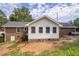 Back exterior view showing the roofline and a glimpse of the backyard at 3642 S Bogan Rd, Buford, GA 30519