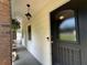 Covered front porch with decorative door, charming light fixture and view of the yard at 3642 S Bogan Rd, Buford, GA 30519