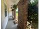 Charming covered front porch with brick columns and lush foliage creating a welcoming outdoor space at 3642 S Bogan Rd, Buford, GA 30519