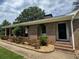 Charming brick home featuring arched entryway, tidy landscaping, and a welcoming covered porch at 3642 S Bogan Rd, Buford, GA 30519