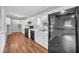 Traditional kitchen with white cabinets, laminate countertops, and black appliances at 3642 S Bogan Rd, Buford, GA 30519