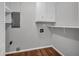 Small laundry room with grey walls, wood floors, and shelving at 3642 S Bogan Rd, Buford, GA 30519