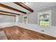 A flexible living area with hardwood floors and exposed beams, perfect for customizing to your tastes at 3642 S Bogan Rd, Buford, GA 30519