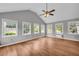 Bright living room with many windows, vaulted ceilings, and beautiful hardwood floors at 3642 S Bogan Rd, Buford, GA 30519