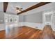 Open-concept living room featuring wood floors, ceiling fan, and light gray walls at 3642 S Bogan Rd, Buford, GA 30519