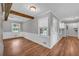 Bright living room with hardwood floors, exposed beams, and abundant natural light, ready for personal touches at 3642 S Bogan Rd, Buford, GA 30519