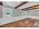 Spacious living room featuring hardwood floors, ample natural light, and exposed beams, ready for you to personalize at 3642 S Bogan Rd, Buford, GA 30519
