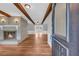 Inviting living room featuring a brick fireplace, exposed beams, and hardwood floors, providing a warm and inviting space at 3642 S Bogan Rd, Buford, GA 30519