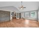 Spacious room featuring wood floors, brick fireplace, and large windows at 3642 S Bogan Rd, Buford, GA 30519