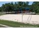 Bogan Park's sand volleyball court and playground are framed by mature trees offering recreational enjoyment at 3642 S Bogan Rd, Buford, GA 30519