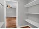 Spacious walk-in closet with shelves and wood floors at 3642 S Bogan Rd, Buford, GA 30519