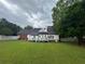 Spacious backyard featuring a well-maintained lawn, white fencing, and a deck perfect for entertaining at 3677 Malachi Way Way, Loganville, GA 30052