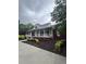 Charming brick home with a welcoming covered front porch, black shutters, and manicured landscaping at 3677 Malachi Way Way, Loganville, GA 30052
