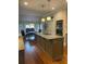 Modern kitchen with a large center island, stainless steel appliances, hardwood floors and recessed lighting at 3677 Malachi Way Way, Loganville, GA 30052