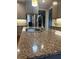 Close-up of the kitchen island featuring granite countertops, stainless steel faucet, and gray cabinetry at 3677 Malachi Way Way, Loganville, GA 30052