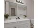 Modern bathroom featuring a vanity with dual sinks, a large mirror, and an enclosed shower at 589 Wilmont Dr, Jonesboro, GA 30238