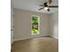 Neutral bedroom with wood-look floors, a ceiling fan, and a bright window at 589 Wilmont Dr, Jonesboro, GA 30238