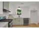 Modern kitchen with gas range, sleek cabinetry, and stainless steel appliances, providing a functional and stylish cooking space at 589 Wilmont Dr, Jonesboro, GA 30238
