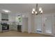 Well-lit kitchen featuring modern appliances, stylish cabinets, and a view to the outside at 589 Wilmont Dr, Jonesboro, GA 30238