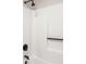 Minimalist shower showcasing white walls, sleek black fixtures, and a convenient grab bar for added accessibility at 589 Wilmont Dr, Jonesboro, GA 30238