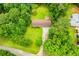 Aerial view of the property showcasing the house, lawn, and surrounding wooded area at 100 Eldorado Dr, Carrollton, GA 30116