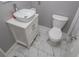 Compact bathroom featuring a modern vanity, toilet, and stylish marble floors at 100 Eldorado Dr, Carrollton, GA 30116