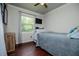 Cozy bedroom featuring a comfortable bed, wood floors, and a bright window view at 100 Eldorado Dr, Carrollton, GA 30116