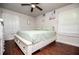 Cozy bedroom showcasing a comfortable bed, ceiling fan and hardwood flooring at 100 Eldorado Dr, Carrollton, GA 30116