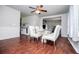 Bright dining room with hardwood floors, ceiling fan, and glass table set at 100 Eldorado Dr, Carrollton, GA 30116