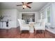 Bright dining room with hardwood floors, ceiling fan, and glass table set at 100 Eldorado Dr, Carrollton, GA 30116