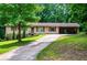 Charming single-story home featuring red accents, attached carport, and a well-maintained front yard at 100 Eldorado Dr, Carrollton, GA 30116
