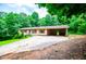 Exterior showcasing the home's front facade, driveway, carport, and landscaping at 100 Eldorado Dr, Carrollton, GA 30116